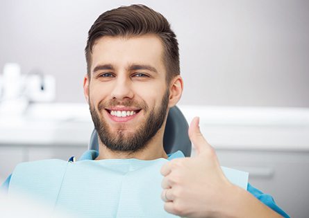 Patient giving thumbs up for Saturday dental services