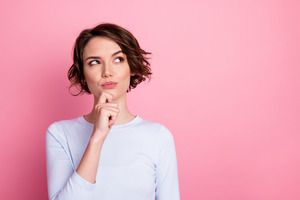 Woman in light blue shirt thinking