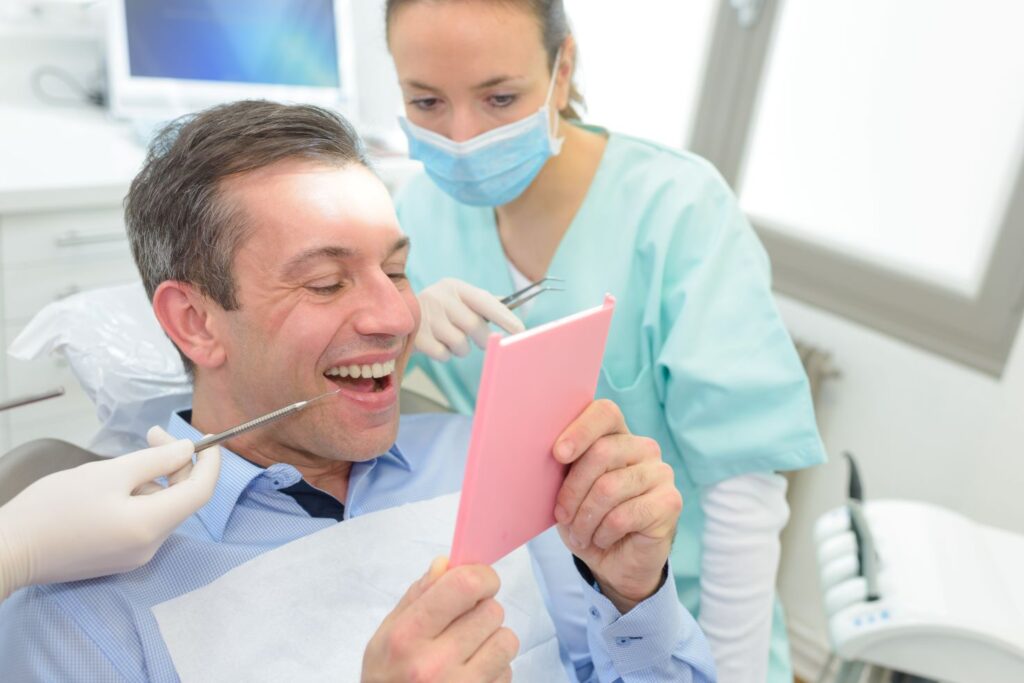 A man at the dentist getting a dental crown.